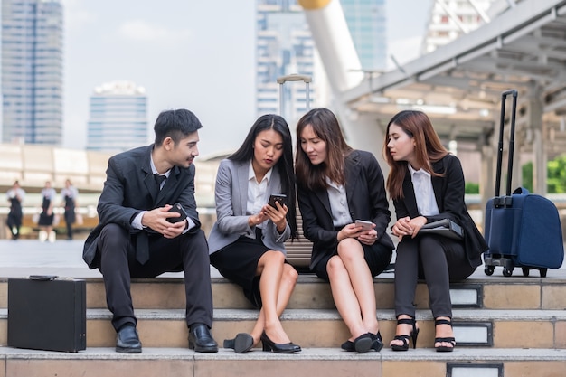 Close up sitting businessman and woman using smart phone