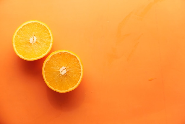 Close up of slice of orange fruit on color background