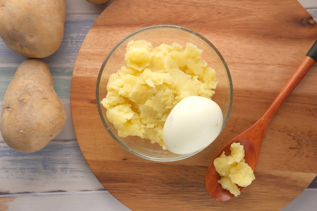 Close up of slice of raw potato in a bowl