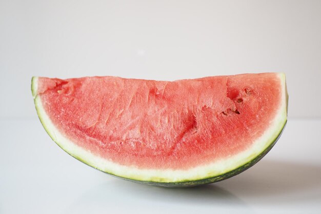 Close up of slice of water melon on white background