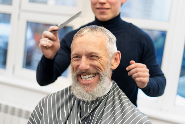 Close up smiley man at hairdresser shop