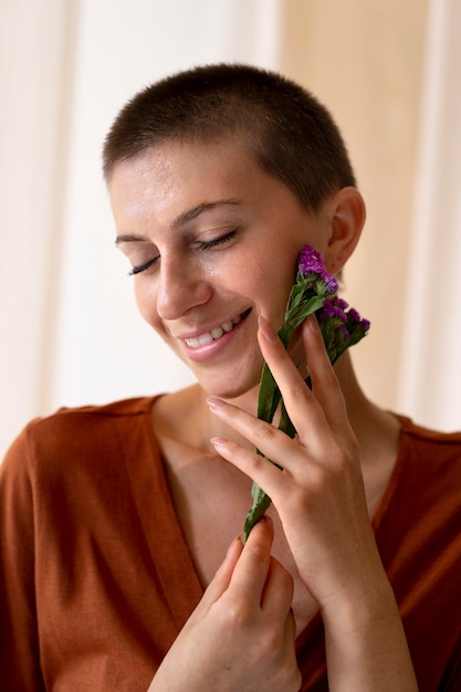 Close up smiley woman posing with flowers