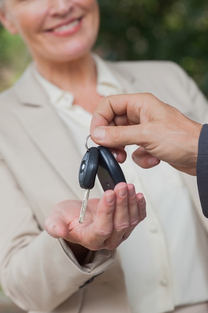 Close up on smiling businesswoman being given keys 