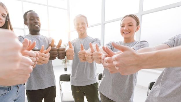 Close up smiling group of young people standing in a circle