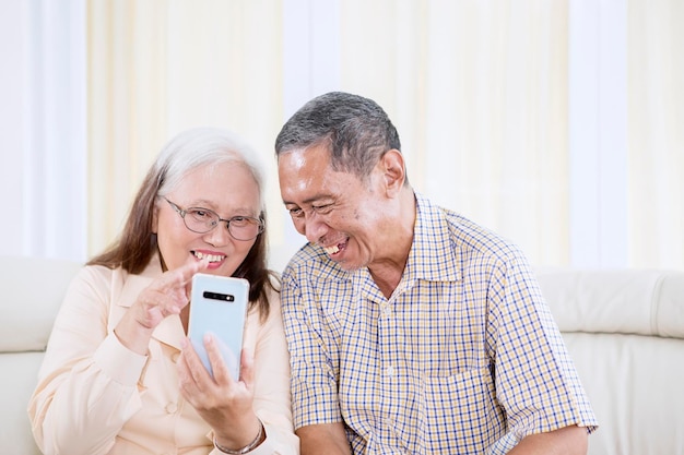 Close up of smiling old couple making a video call