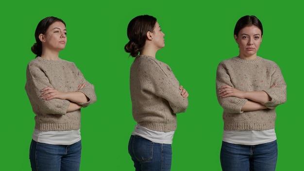 Close up of smiling person with sweater acting lovely over isolated greenscreen backdrop in studio. Modern person being positive and happy, confident model on camera over green screen.