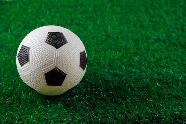 Close up of soccer ball on green background