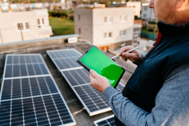 Close up of solar energy technician mounting blue solar module eco concept alternative energy high q