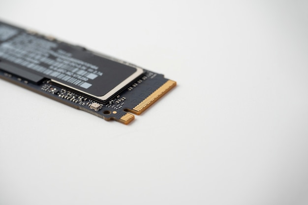 Close-up of a solid-state hard drive with an m2 interface on a white background. Selective focus, copy space