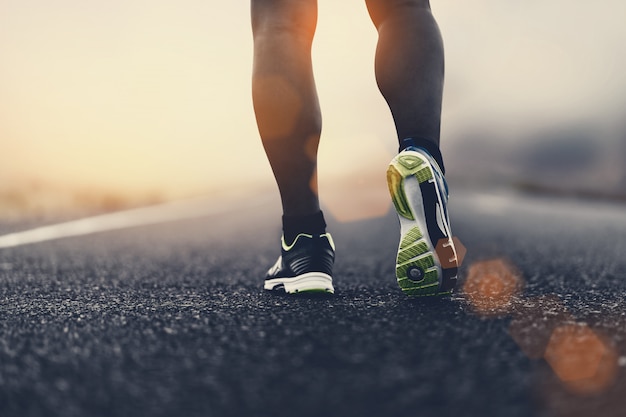 Close up sport shoes of a runner on road for fitness healthy lifestyle.