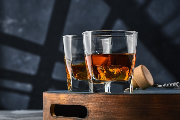 Close up of square glasses of whiskey with ice