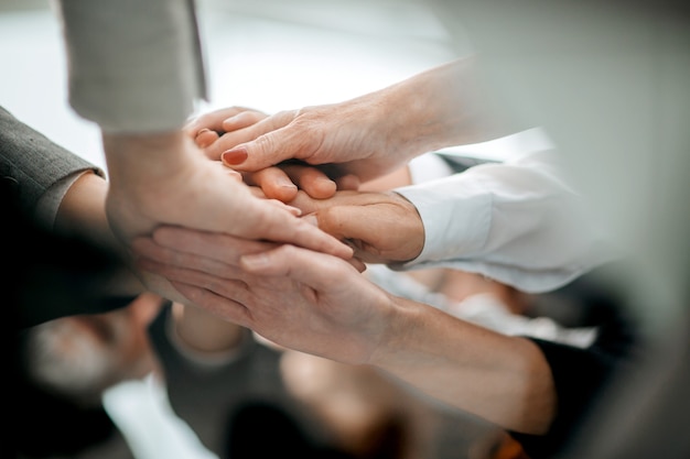 Close up a stack of hands the concept of unity