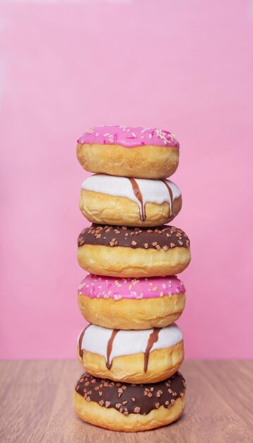 Close-up of stacked donuts against pink background