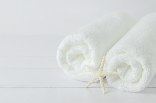 Close up of starfish and white roll towels