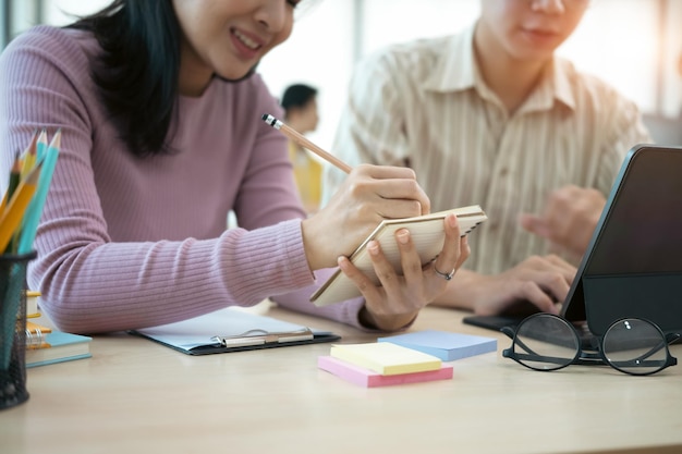 Close up startup employee consulting on office table