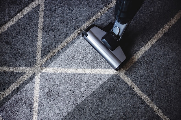 Close up of steam cleaner cleaning very dirty carpet.