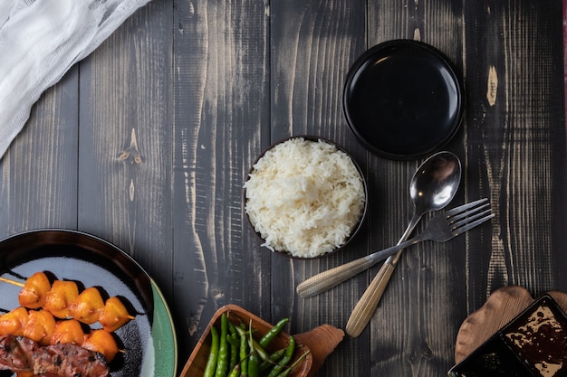 Close up of steamed rice with grilled chicken