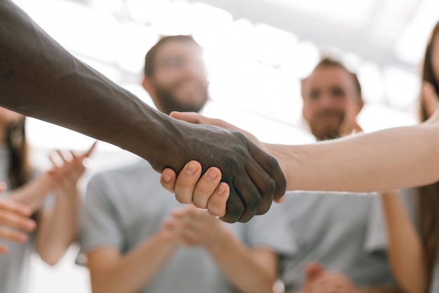 Close up. strong handshake of two students of different nationalities