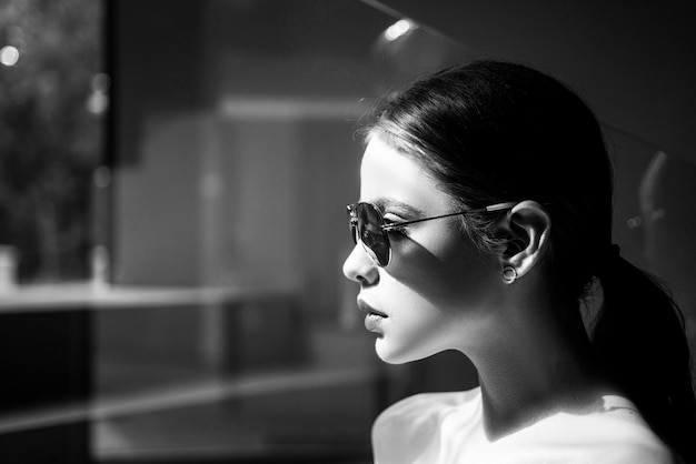 Close up of stylish young woman in sunglasses beautiful female model fashion trend