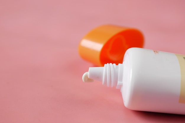 Close up of sunscreen cream in a pink container