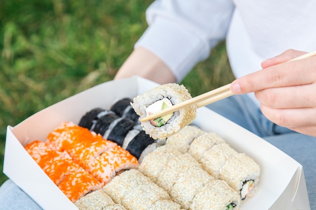 Close up of sushi in box at picnic sushi delivery concept