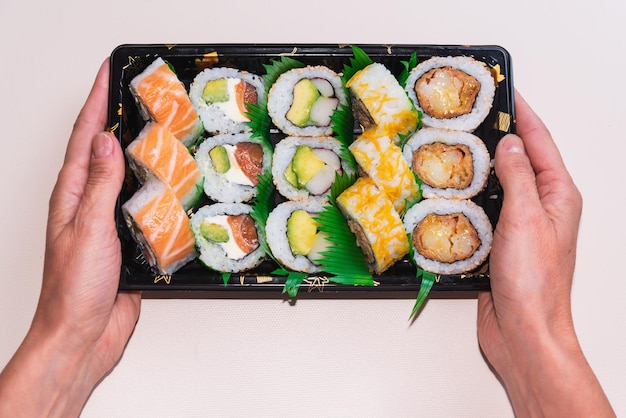 Close up of sushi tray delivery fish soy sauce fast food packaged food