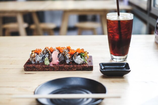 Close-up of sushi with drink served on table