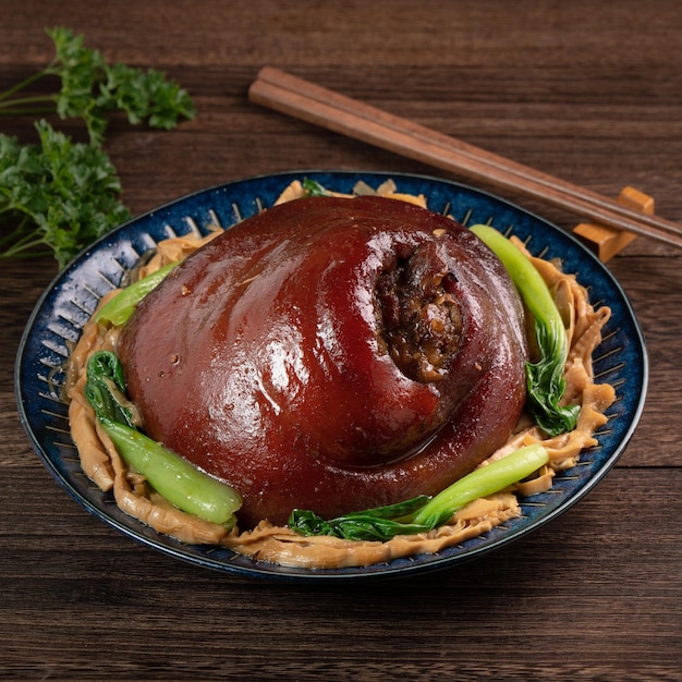 Close up of Taiwanese food braised pork hock food in a plate on rustic table background