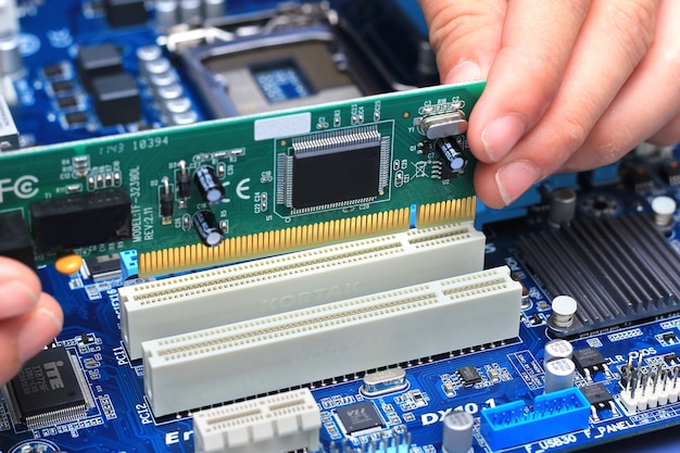 Close-up of technician's hand assembling personal computer