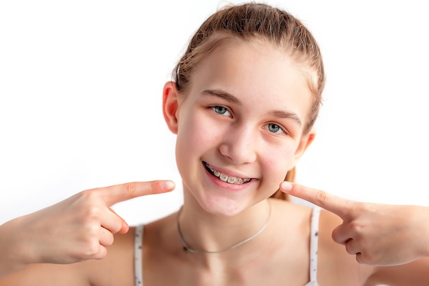 Close up of a teenage girl smiling in orthodontic brackets banner Girl with braces on teeth