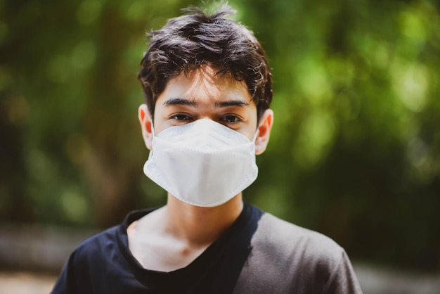 Close up of teenager boy wearing mask with smile