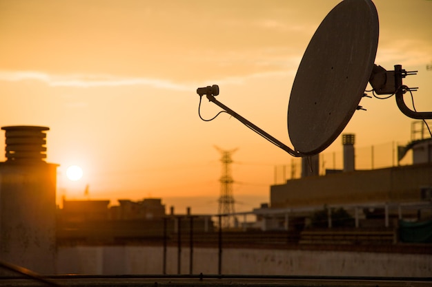 Photo a close up of television antenna with sunset in the background