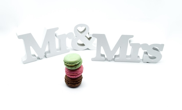 Photo close-up of text and macaroons on white background