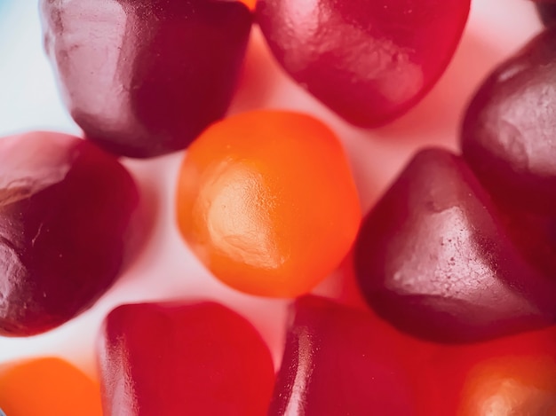 Close-up texture of red, orange and purple multivitamin gummies. Healthy lifestyle concept.