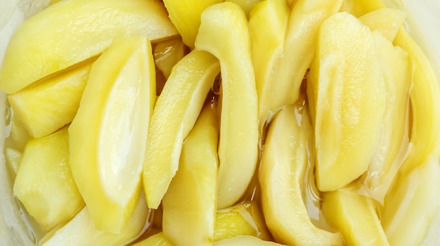 Close up of Thai pickled mangoes in a bowl.