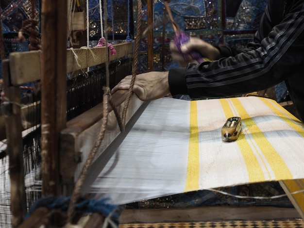 Close up of the threads in a wooden loom in a textile store in Fes, Morocco