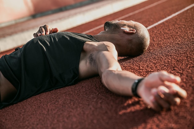 Close up of tired athlete relaxing after run