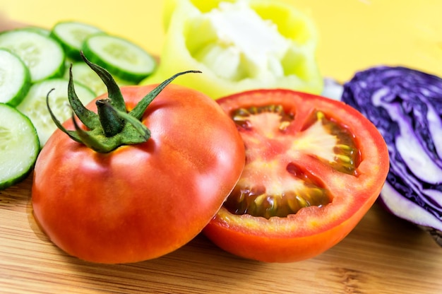 Close up of tomato cut in half on wooden board