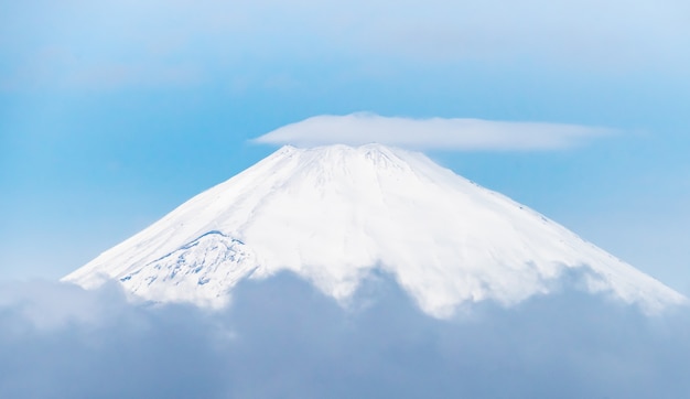 Close up top view of Fuji mountain with snow cover with could