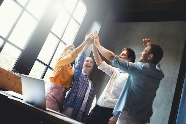 Close up top view of young business people putting their hands together Stack of hands teamwork