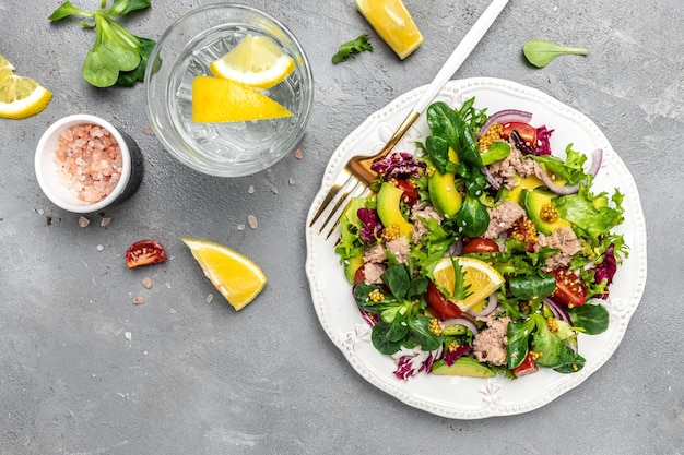 Close up tuna salad with lettuce cherry tomatoes avocado and red onions superfood concept Healthy clean eating concept Vegan or gluten free diet Top view