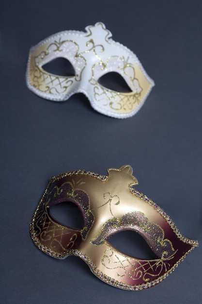 Close up of two beautiful carnival masks on grey background