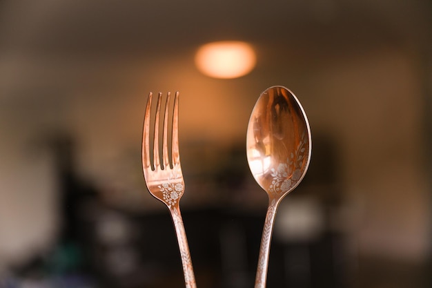 A close up of two forks with the word " on the front. "