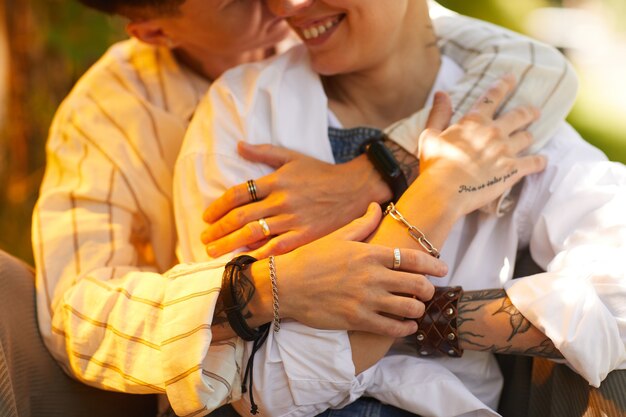 Close-up of two girlfriends embracing each other while resting outdoors