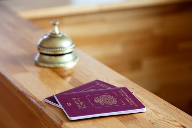 Close-up two russian passports at wooden reception desk