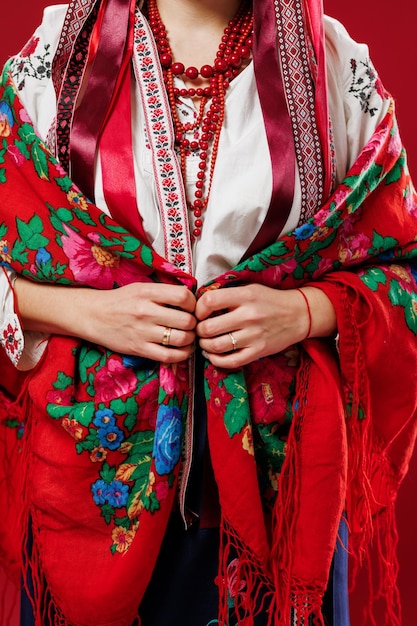 Close up of ukrainian woman in traditional ethnic clothing on viva magenta studio background Ukrainian national embroidered dress call vyshyvanka Pray for Ukraine