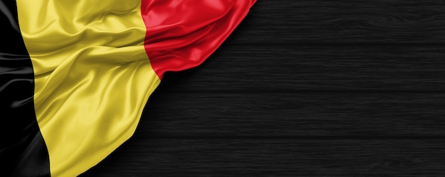 Close up of united states of Belgian flag on the black wooden background 3d render