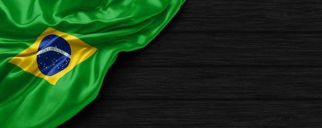 Close up of united states of Brazil flag on the black wooden background 3d render