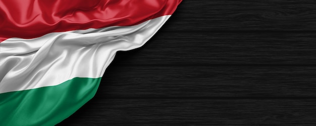 Close up of united states of Hungary flag on the black wooden background 3d render