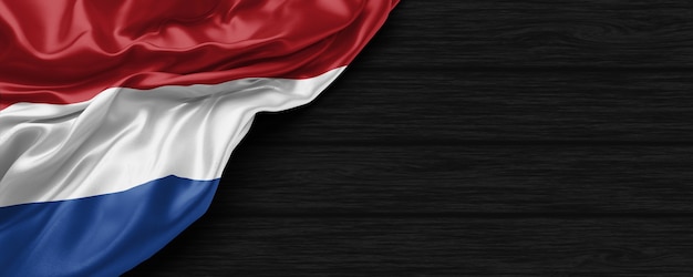 Close up of united states of Netherlands flag on the black wooden background 3d render